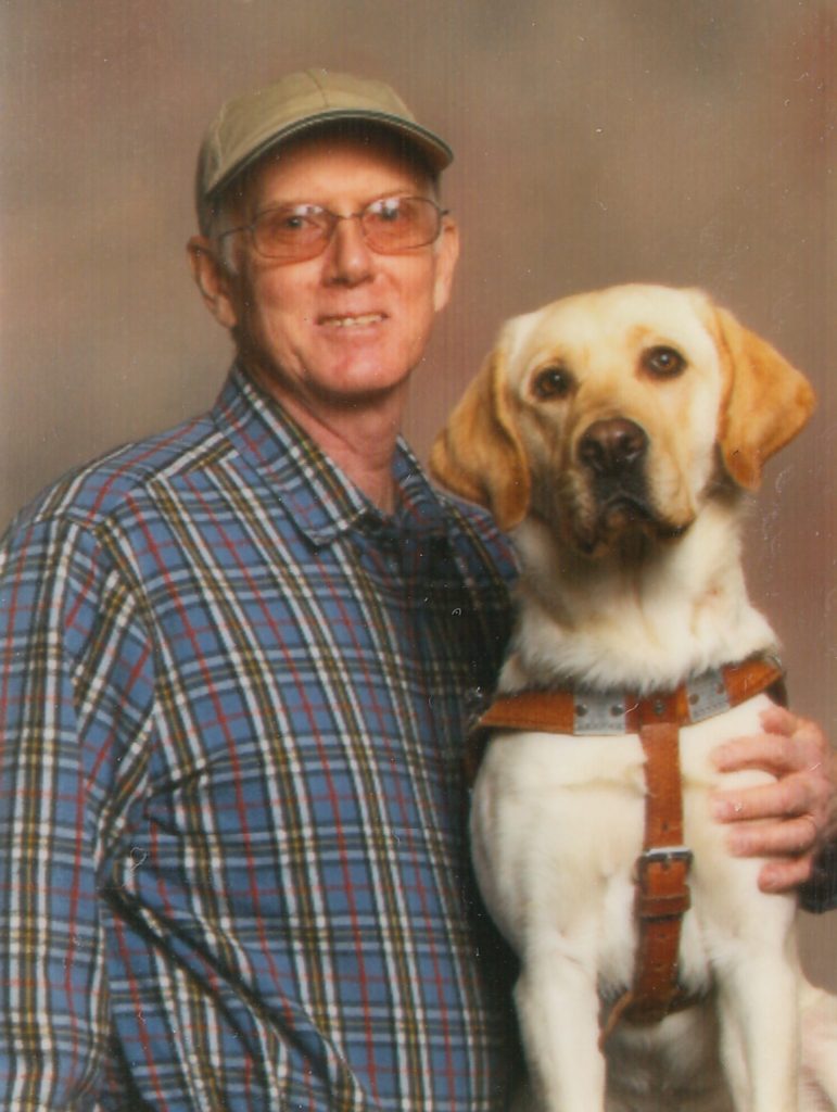 Steve posing with his former Seeing Eye dog Razz, an elegant yellow Lab.