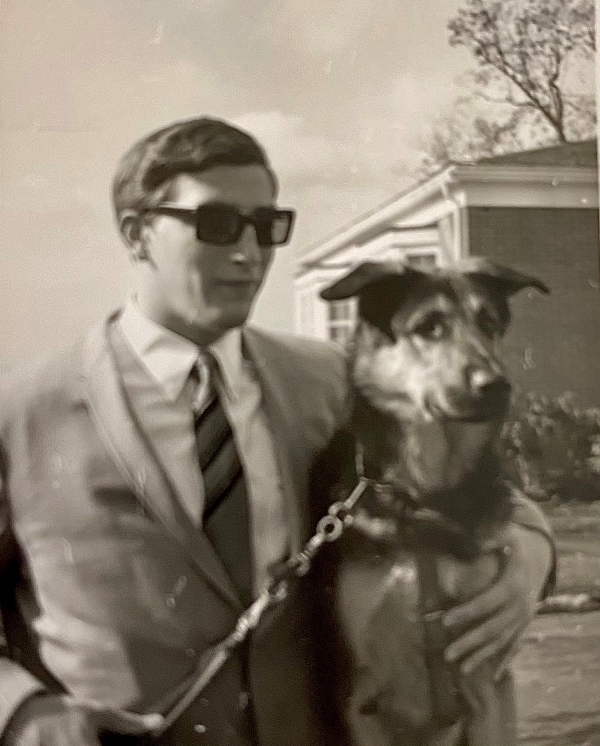 Black and white portrait of Mike standing with his first Seeing Eye dog Rick