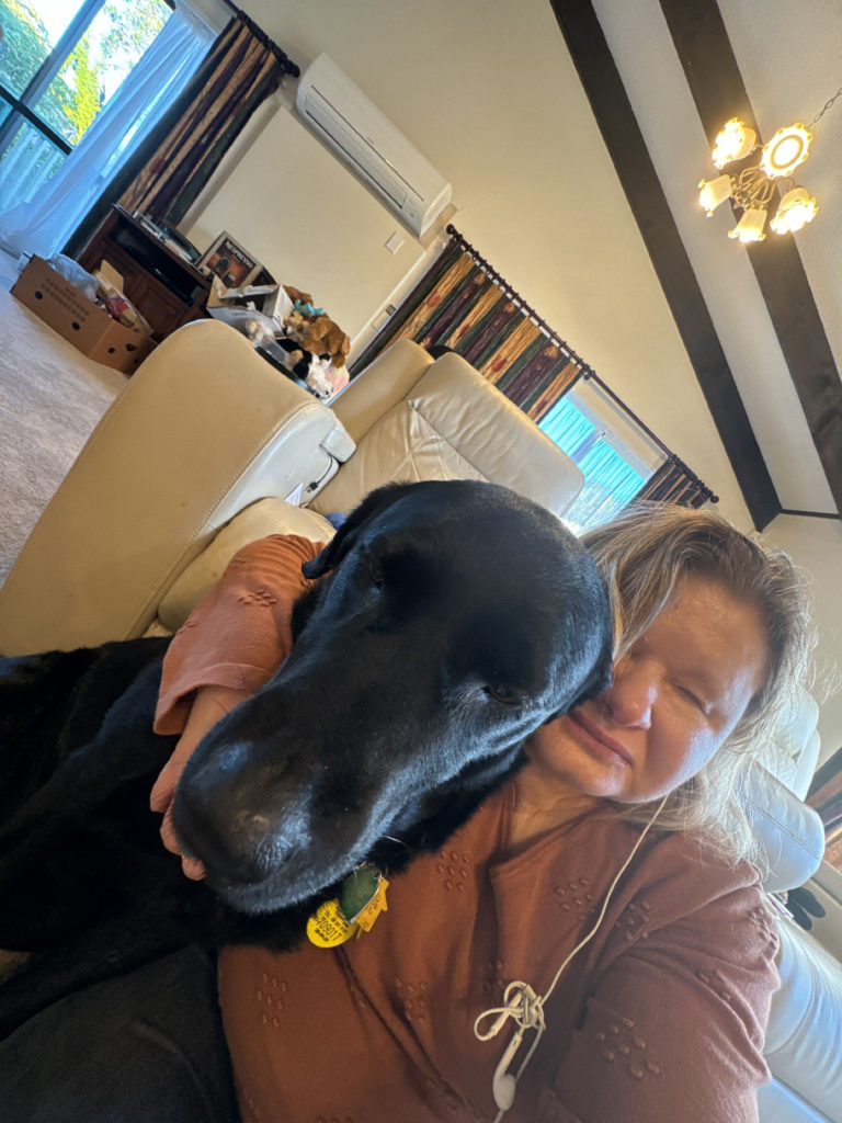 Bonnie and her Seeing Eye dog Eclipse sitting together on the floor